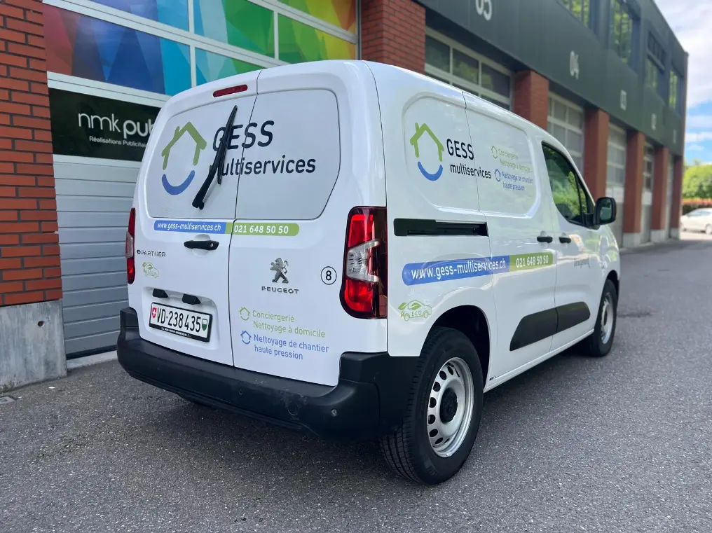a white van parked in front of a building