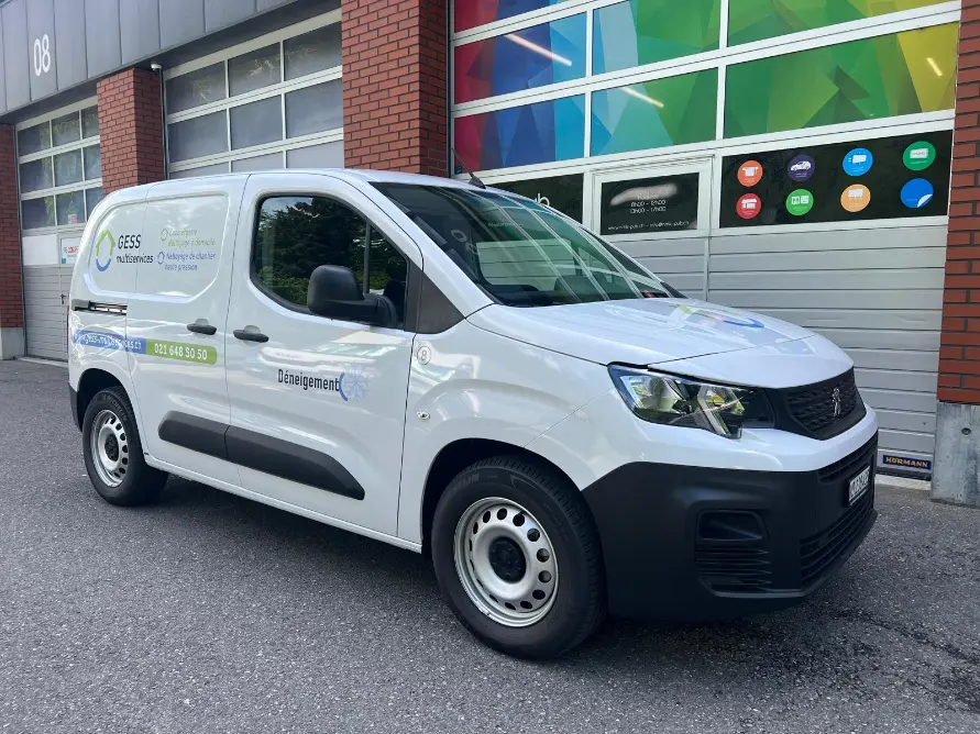 a white van parked in front of a building