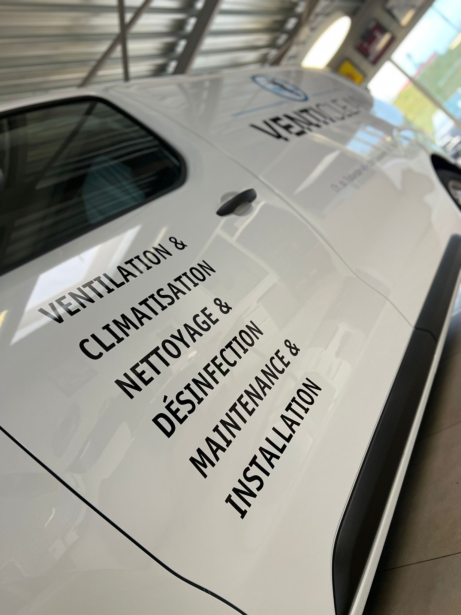 a white car with black text on it