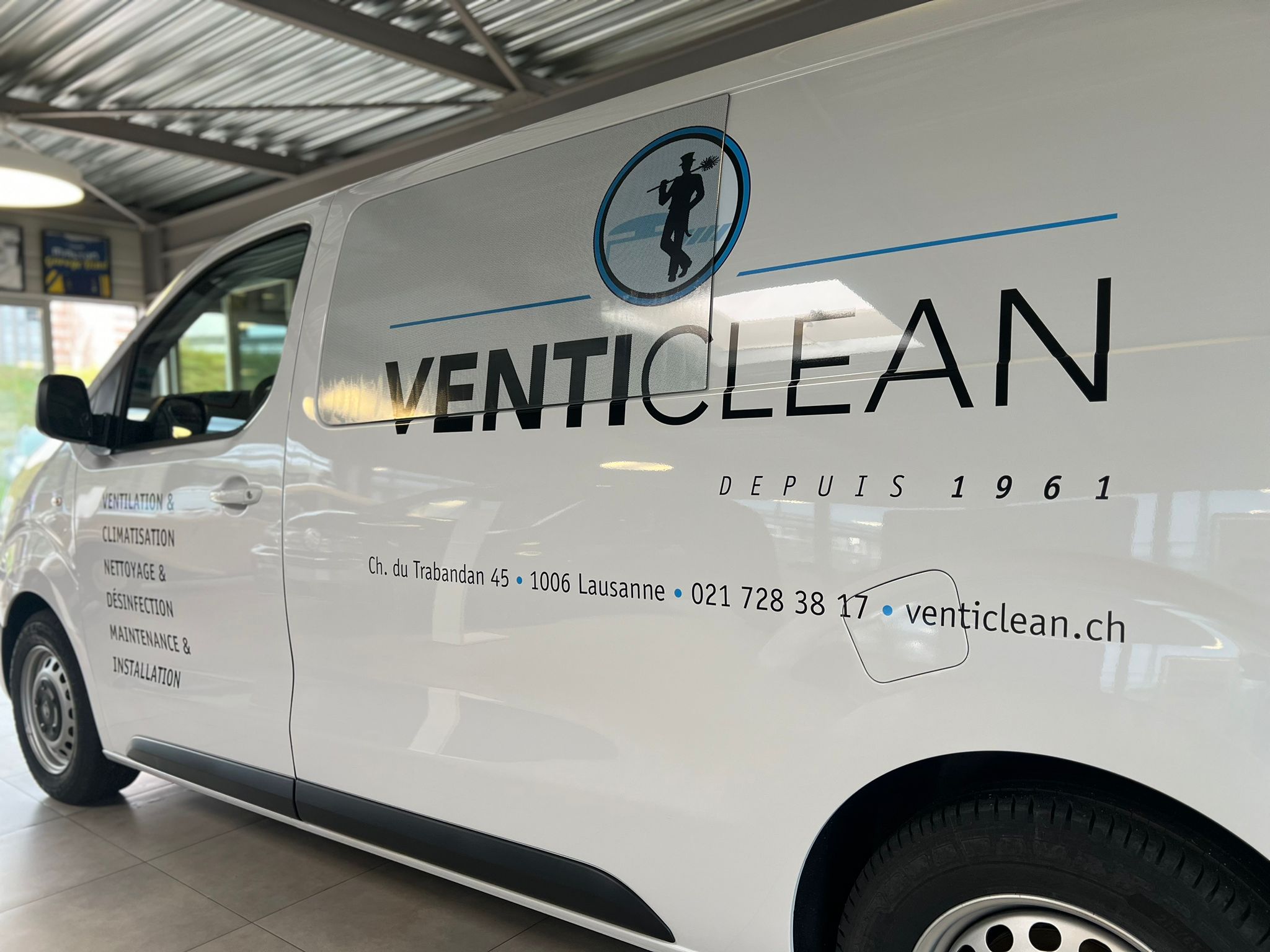 a white van with black text on it