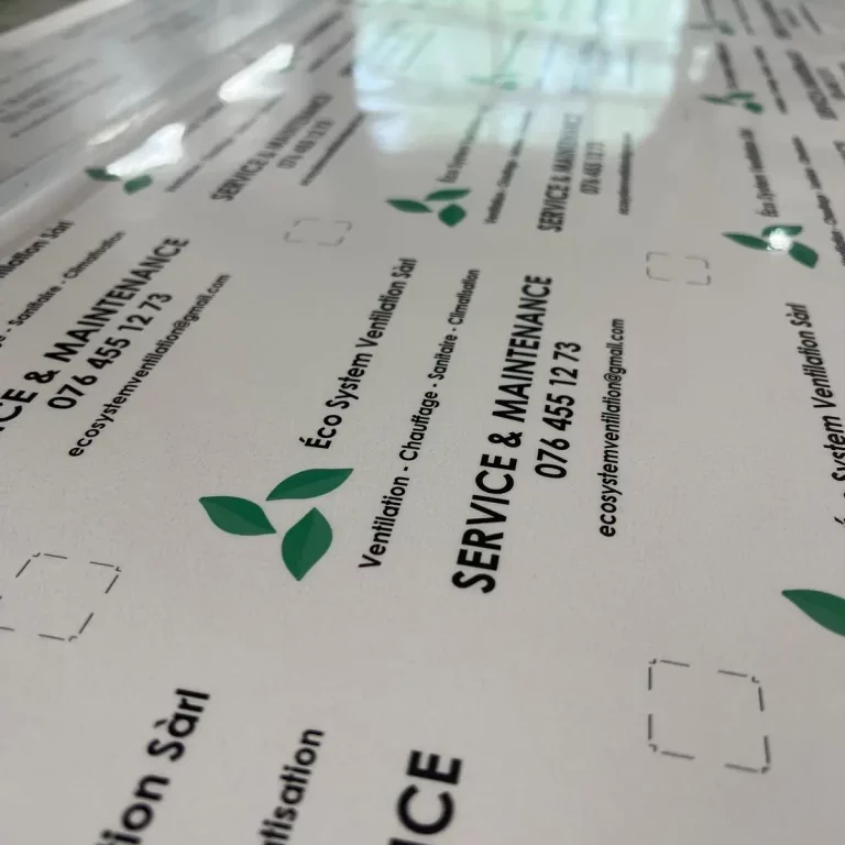 a white sign with green leaves on it